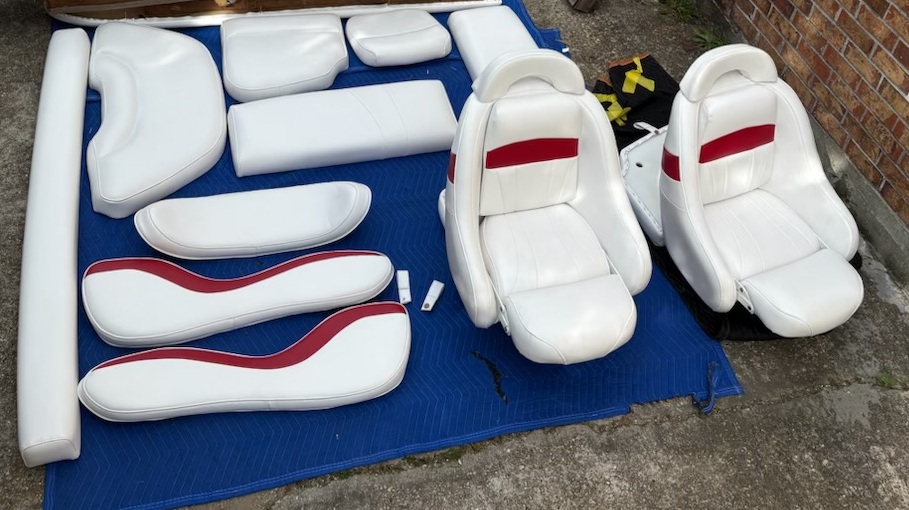 Complete set of white and red boat seats and cushions after reupholstery