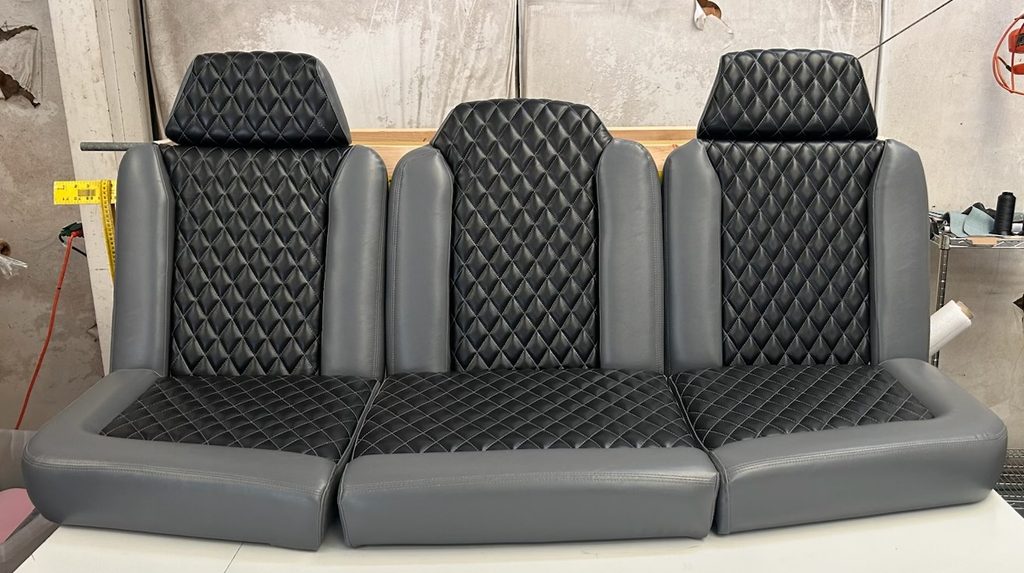 Custom black and gray boat seats with diamond-stitched marine upholstery