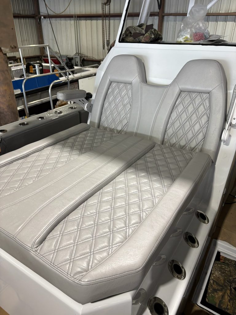 Custom gray boat seating with diamond-stitched marine upholstery