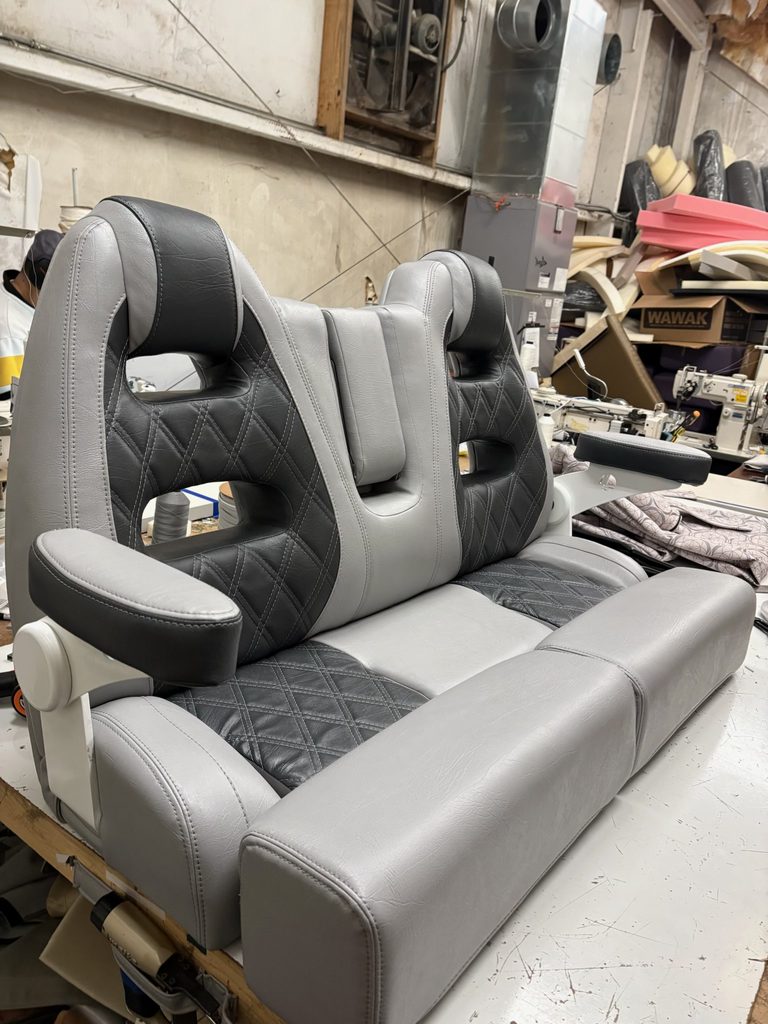 Custom gray and black boat seating with diamond stitching and armrests