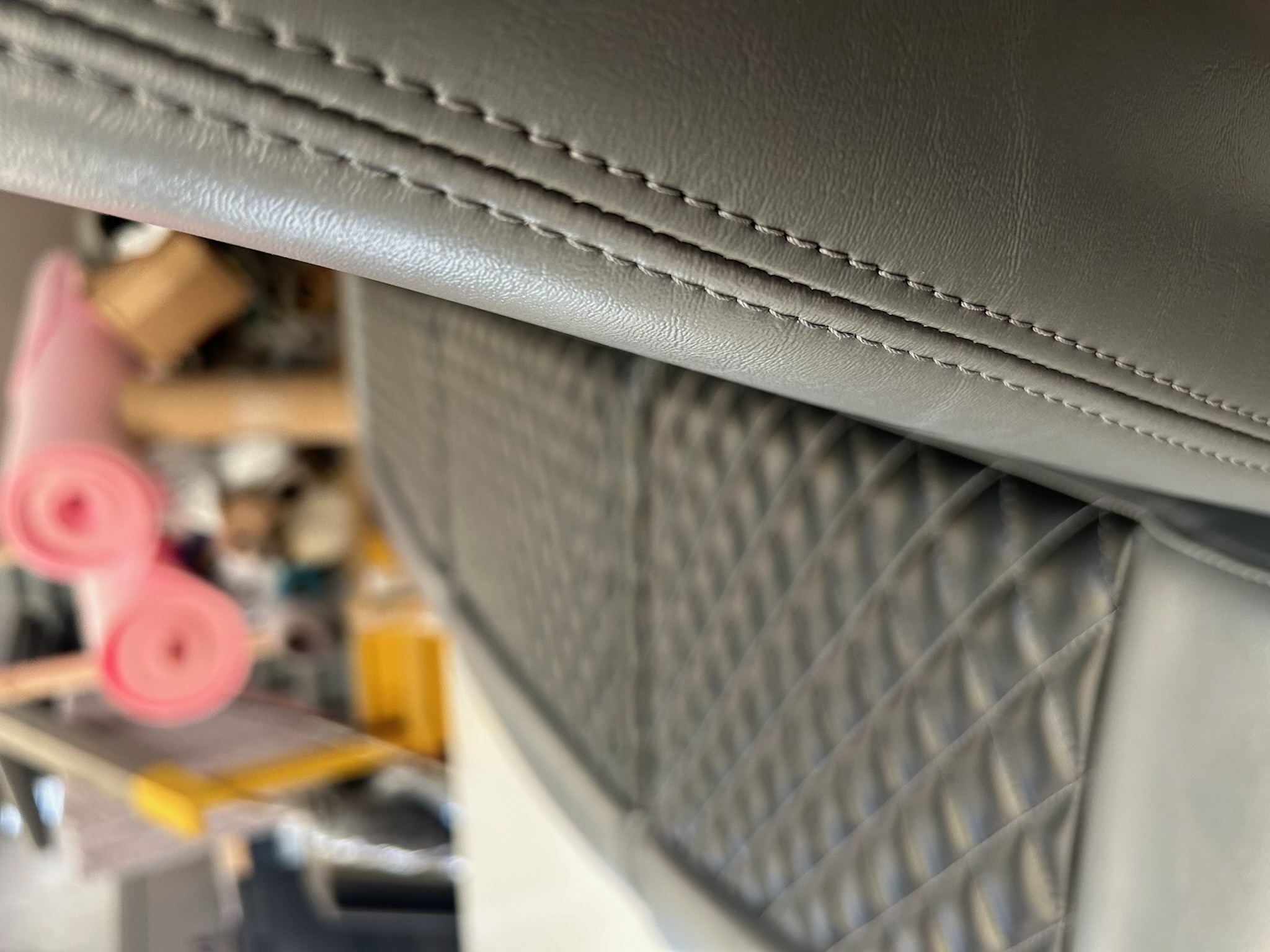 Close-up of custom stitching and diamond-pattern marine upholstery